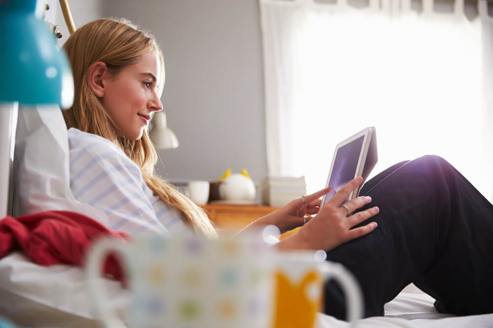 A young person setting up an online fundraising page on a tablet.