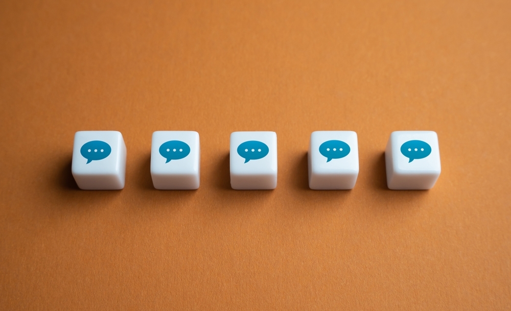 White blocks with icons of messages, against an orange background.