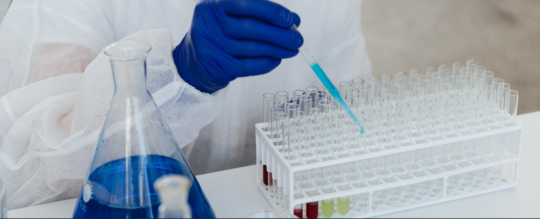 Image shows a scientist conducting work in a laboratory environment.