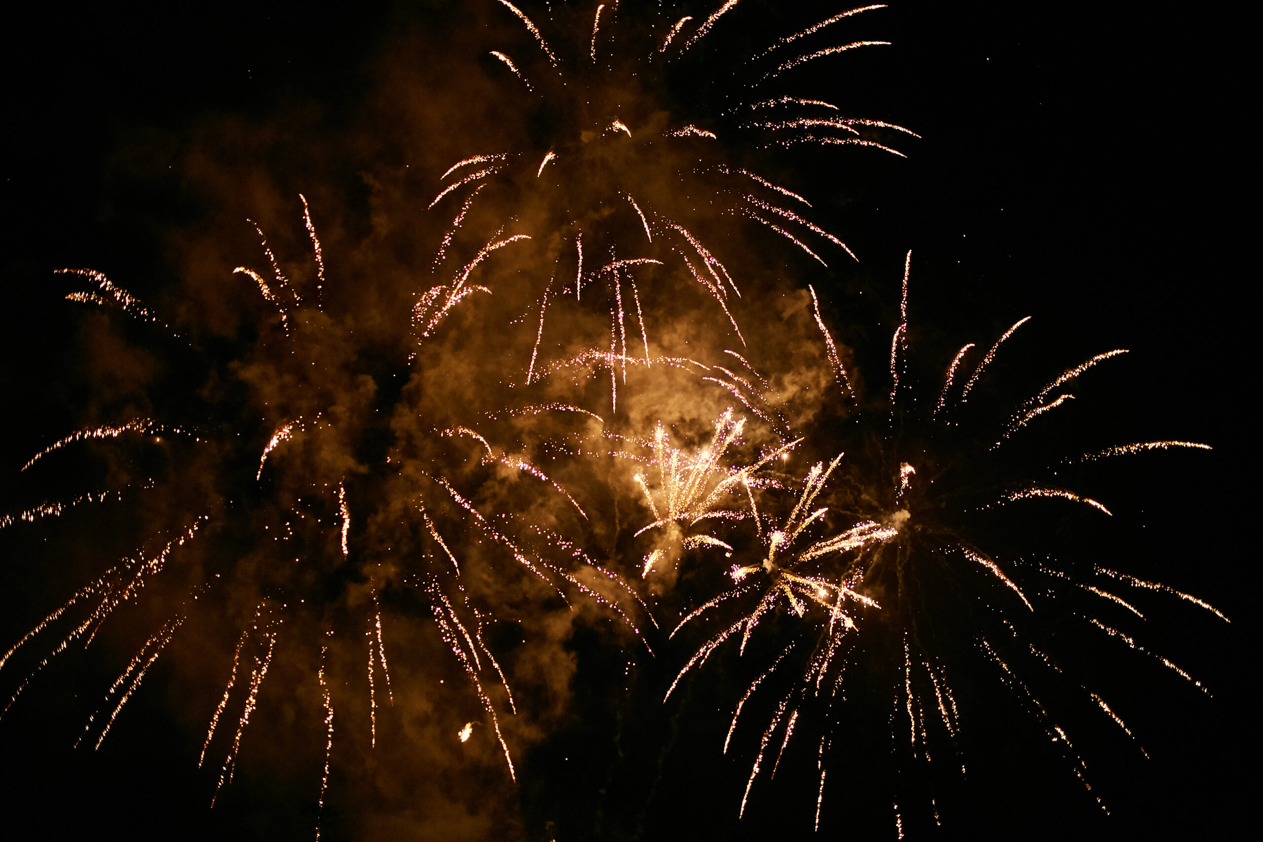 Golden fireworks explosion at night